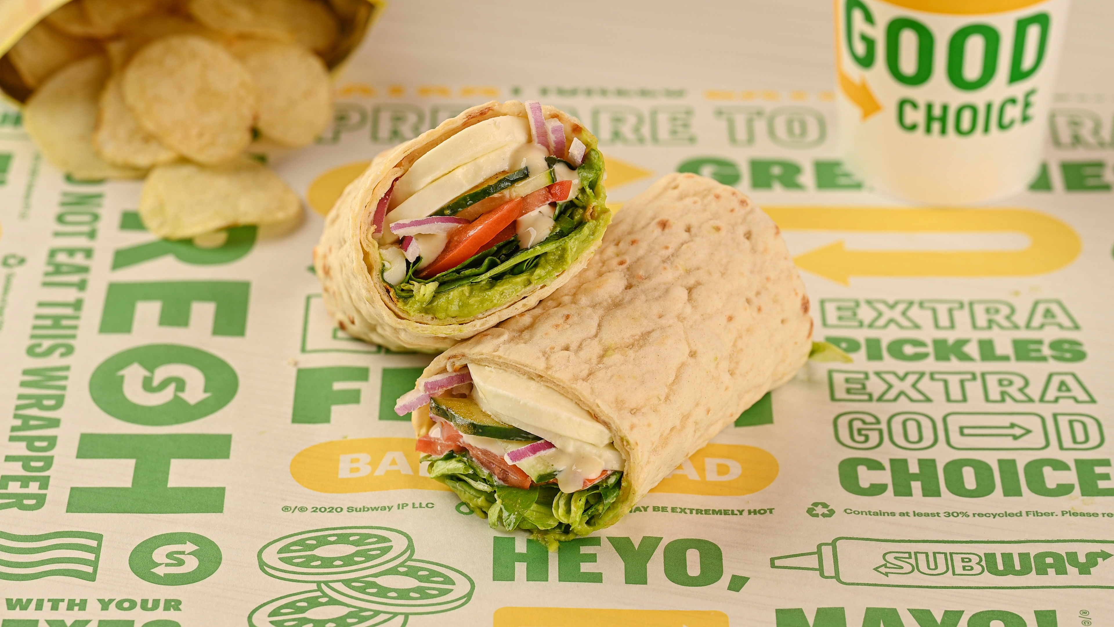 Subway cali caprese wrap on sandwich paper with chips and cup